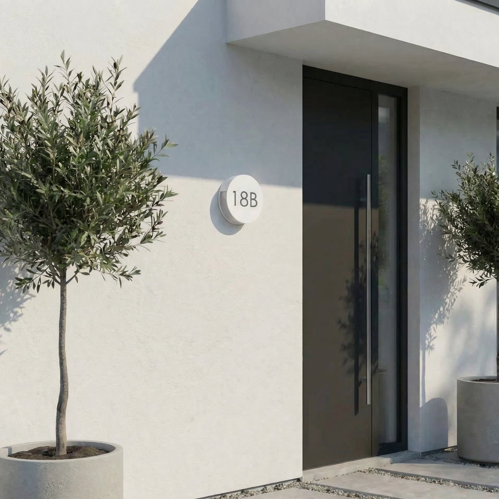 LED utevegglampe Advero med husnummer CCT Ø23 cm lysegrå montert på vegg